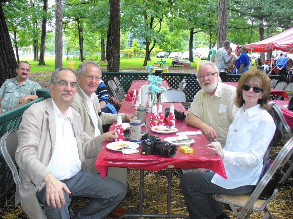 Group of Luxembourg Brotherhood sitting around a picnic table in a park