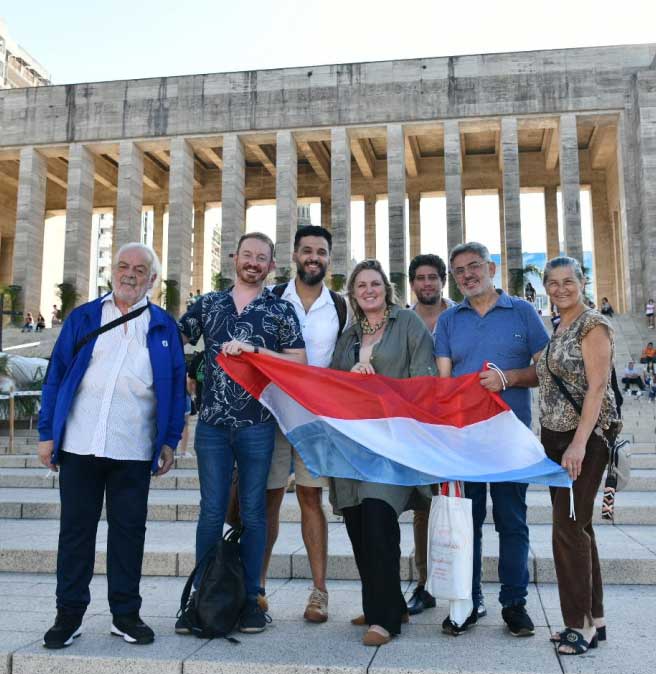 Group of Argentinian-Luxembourger dual citizens in front of grand historic building with Roman columns