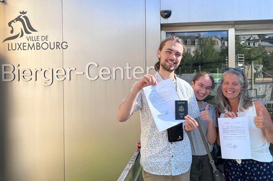 Three people holding dual citizenship certification in Luxembourg