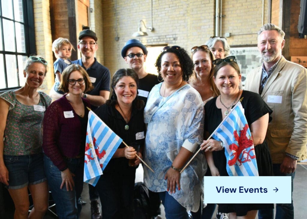 Group of Argentina-Luxembourg dual citizens at a community event holding Argentinian flags