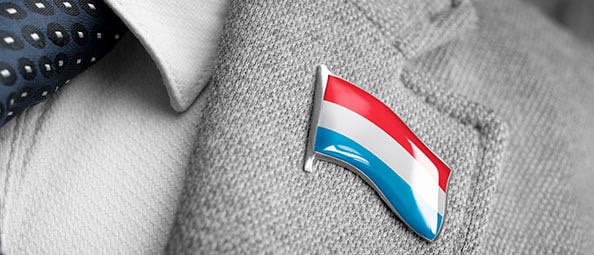 Luxembourg flag pin on lapel of a suit