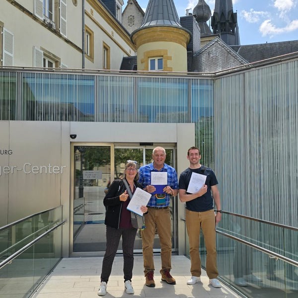 Three LuxCitizenship clients with their Luxembourg citizenship declarations at the Bierger-Center, Luxembourg City