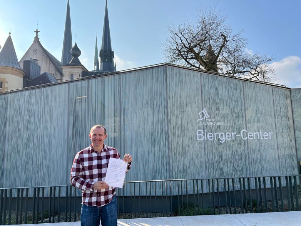 LuxCitizenship client holding his Luxembourg citizenship declaration outside the Bierger-Center in Luxembourg City